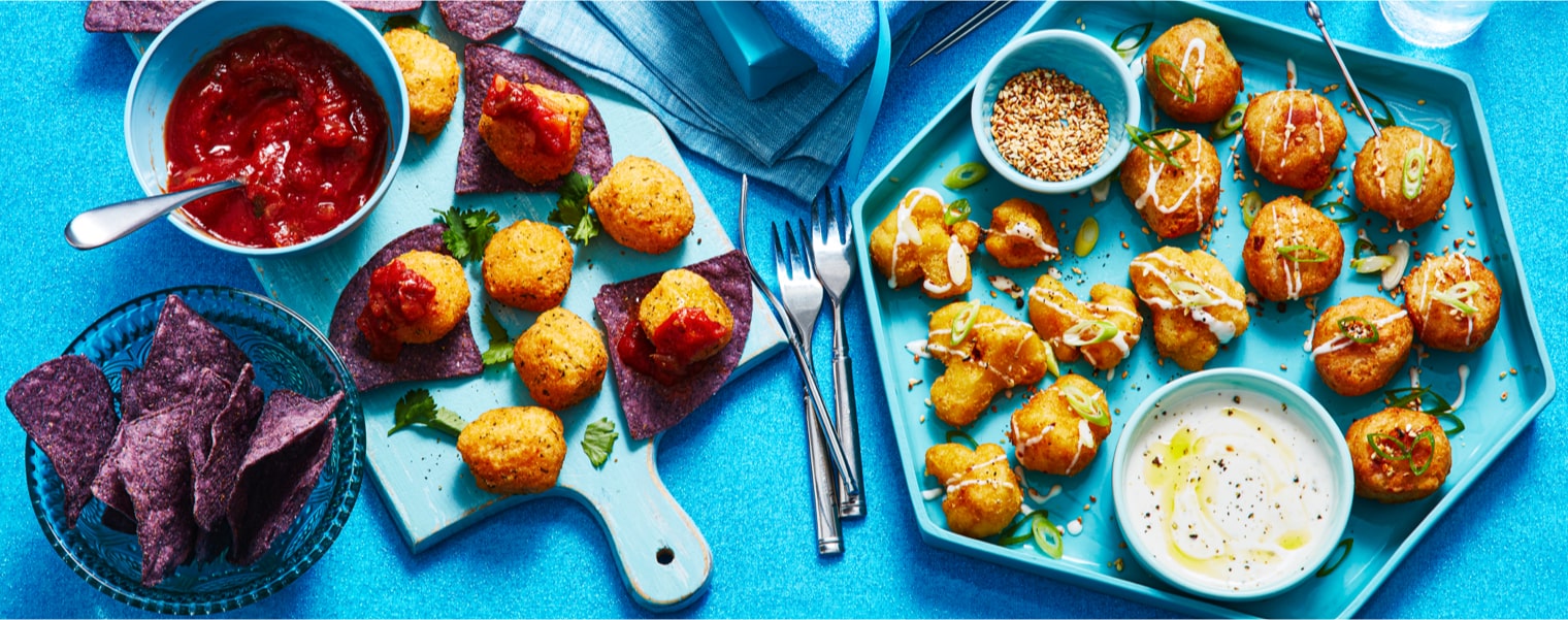 amp-up-holiday-appetizers Holiday appetizer plates filled with shrimp, meatball skewers and sausage rolls