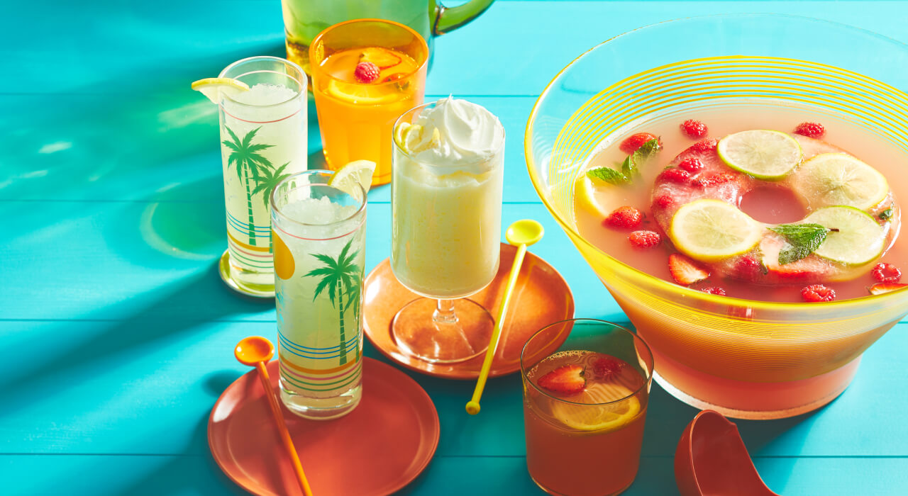 Aqua wooden tabletop set with variety of lemonade drinks and lemonade punch