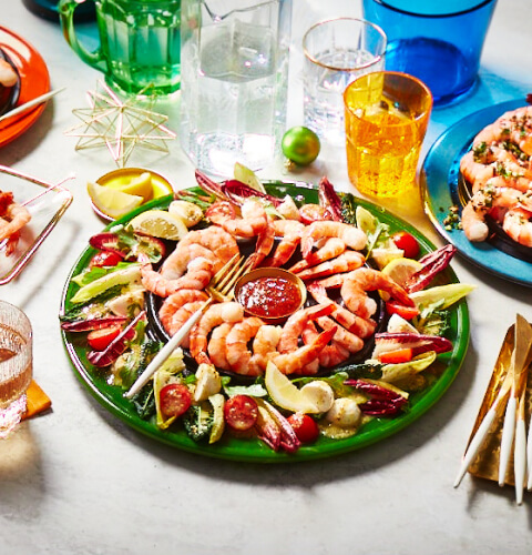 3_ways to_serve a_shrimp ring Marble table with three shrimp ring appetizers set out: shrimp ring with gremolata, shrimp ice ring wreath and a shrimp ring with romesco-style dipping sauce