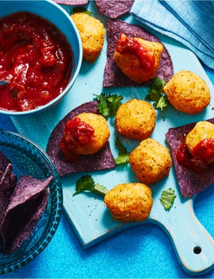 Holiday appetizer plates filled with shrimp, meatball skewers and sausage rolls