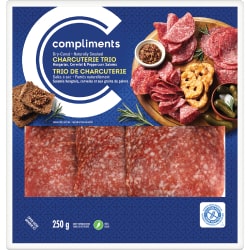 Clear plastic package of Compliments Charcuterie Trio (Hungarian, Cervelat and Peppercorn) with blue label.