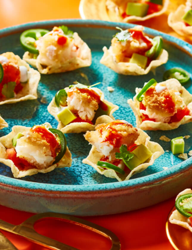 Plate of fish taco bites on orange table