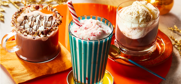 Photo of hazelnut hot chocolate, frozen white hot chocolate, and whipped white hot chocolate over coffee