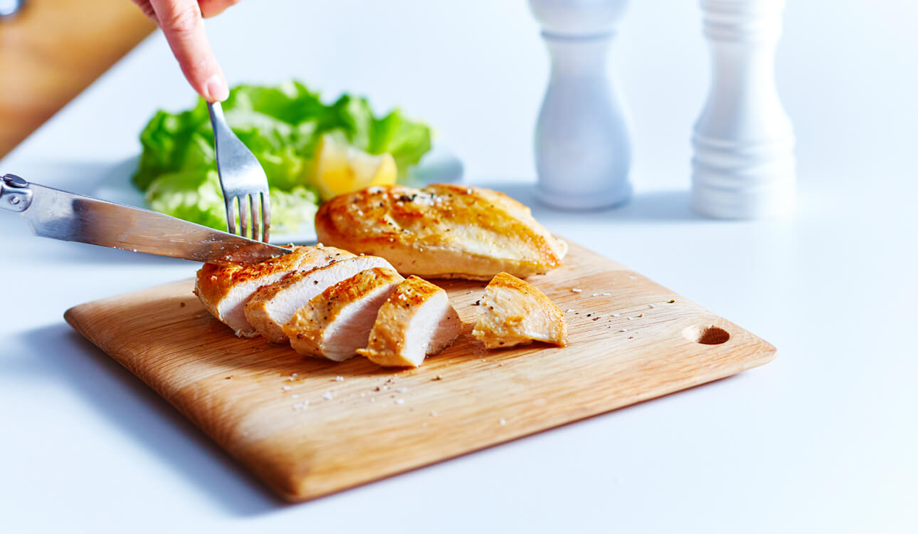 Chicken breast sliced on cutting board